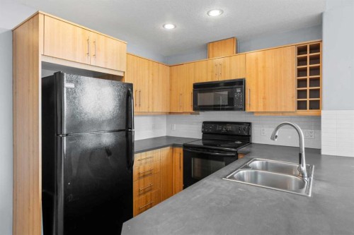 407-55 Spruce Place Sw, Calgary, AB - Indoor Photo Showing Kitchen With Double Sink