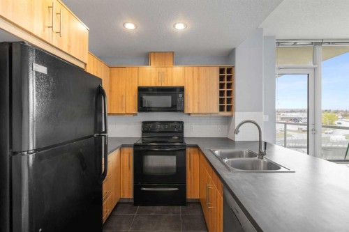 407-55 Spruce Place Sw, Calgary, AB - Indoor Photo Showing Kitchen With Double Sink