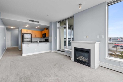 407-55 Spruce Place Sw, Calgary, AB - Indoor Photo Showing Other Room With Fireplace