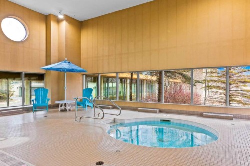 407-55 Spruce Place Sw, Calgary, AB - Indoor Photo Showing Other Room With In Ground Pool