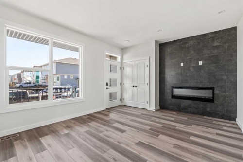 31 Setonvista Way Se, Calgary, AB - Indoor Photo Showing Living Room With Fireplace