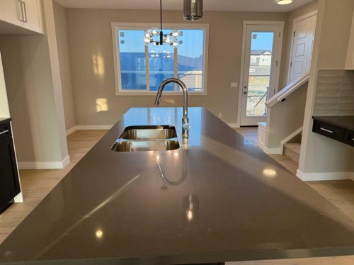 302 Sundown Road, Cochrane, AB - Indoor Photo Showing Kitchen With Double Sink