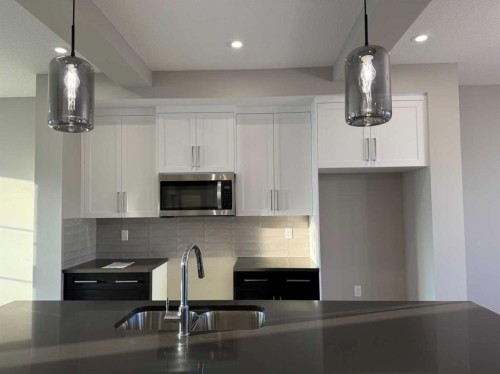 302 Sundown Road, Cochrane, AB - Indoor Photo Showing Kitchen With Double Sink With Upgraded Kitchen