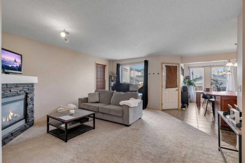 100 Covecreek Close Ne, Calgary, AB - Indoor Photo Showing Living Room With Fireplace