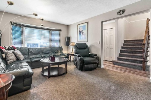 36 Millside Way Sw, Calgary, AB - Indoor Photo Showing Living Room