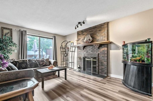 36 Millside Way Sw, Calgary, AB - Indoor Photo Showing Living Room With Fireplace