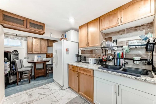 203 Penbrooke Close Se, Calgary, AB - Indoor Photo Showing Kitchen With Double Sink