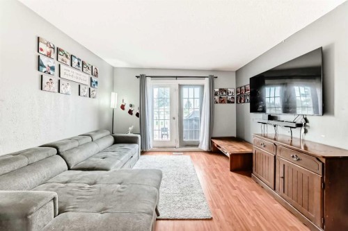 203 Penbrooke Close Se, Calgary, AB - Indoor Photo Showing Living Room
