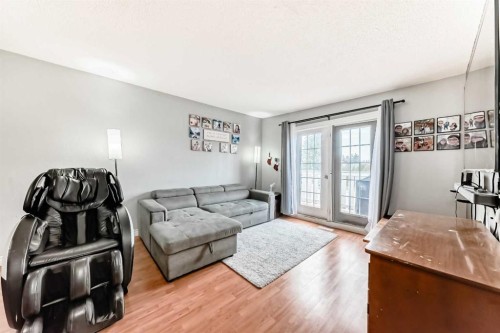 203 Penbrooke Close Se, Calgary, AB - Indoor Photo Showing Living Room