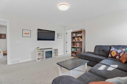 57 Ranchers Way, Okotoks, AB - Indoor Photo Showing Living Room With Fireplace