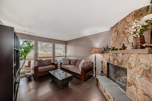 554 Whitehill Place Ne, Calgary, AB - Indoor Photo Showing Living Room With Fireplace