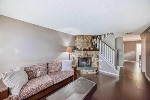 554 Whitehill Place Ne, Calgary, AB - Indoor Photo Showing Living Room With Fireplace