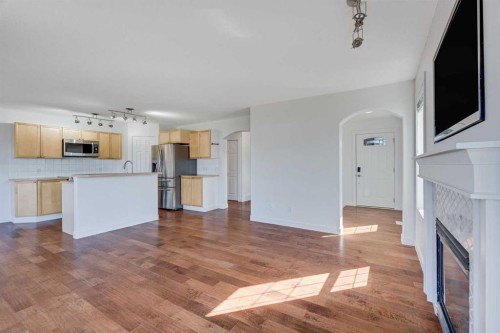 201 Crystalridge Rise, Okotoks, AB - Indoor Photo Showing Kitchen With Fireplace