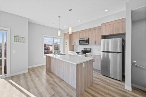 384 Canals Crossing Sw, Airdrie, AB - Indoor Photo Showing Kitchen With Upgraded Kitchen