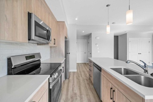 384 Canals Crossing Sw, Airdrie, AB - Indoor Photo Showing Kitchen With Double Sink