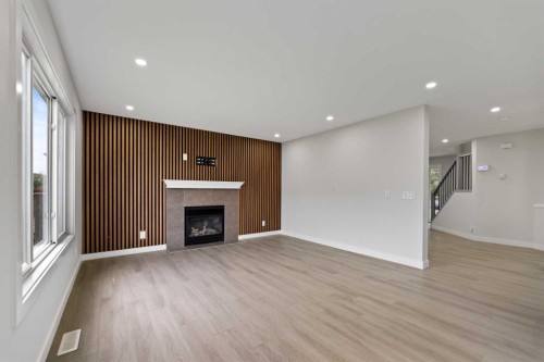 81 Saddlecrest Green Ne, Calgary, AB - Indoor Photo Showing Living Room With Fireplace