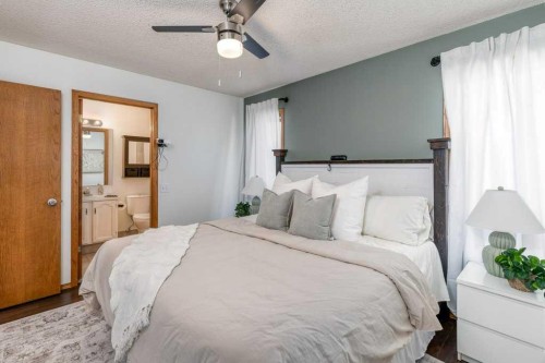 21 West Mcdougal Road, Cochrane, AB - Indoor Photo Showing Bedroom