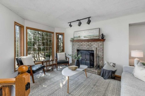 21 West Mcdougal Road, Cochrane, AB - Indoor Photo Showing Living Room With Fireplace
