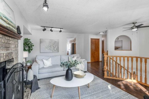 21 West Mcdougal Road, Cochrane, AB - Indoor Photo Showing Living Room With Fireplace