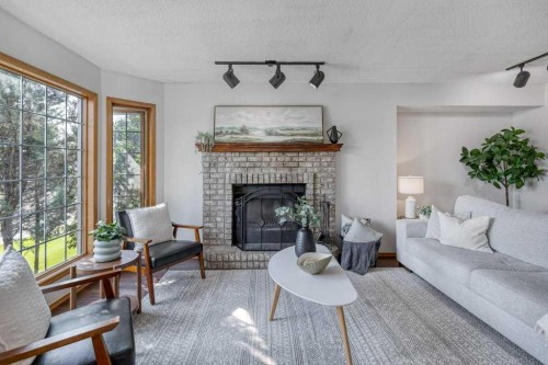 21 West Mcdougal Road, Cochrane, AB - Indoor Photo Showing Living Room With Fireplace