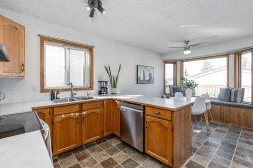 21 West Mcdougal Road, Cochrane, AB - Indoor Photo Showing Kitchen With Double Sink
