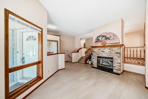 247 Shawinigan Drive Sw, Calgary, AB - Indoor Photo Showing Living Room With Fireplace
