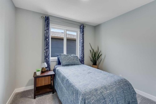211 Willow Place, Cochrane, AB - Indoor Photo Showing Bedroom
