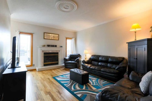 1118 Maple Avenue, Crossfield, AB - Indoor Photo Showing Living Room With Fireplace