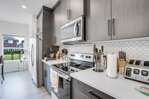 28 Midtown Close Sw, Airdrie, AB - Indoor Photo Showing Kitchen With Stainless Steel Kitchen With Upgraded Kitchen