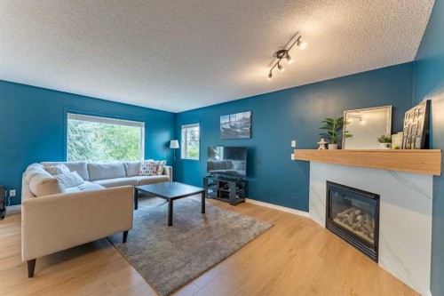 76 Cranfield Place Se, Calgary, AB - Indoor Photo Showing Living Room With Fireplace