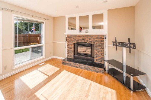 16 Sunhaven Way Se, Calgary, AB - Indoor Photo Showing Living Room With Fireplace