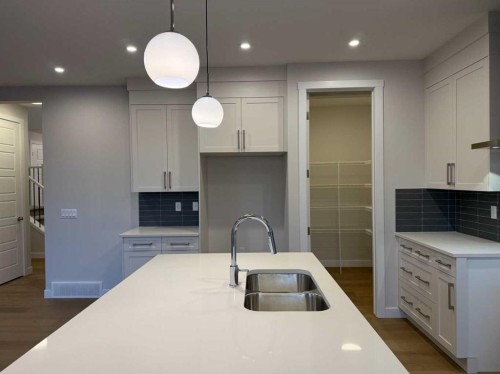 51 Sunrise Heath, Cochrane, AB - Indoor Photo Showing Kitchen With Double Sink