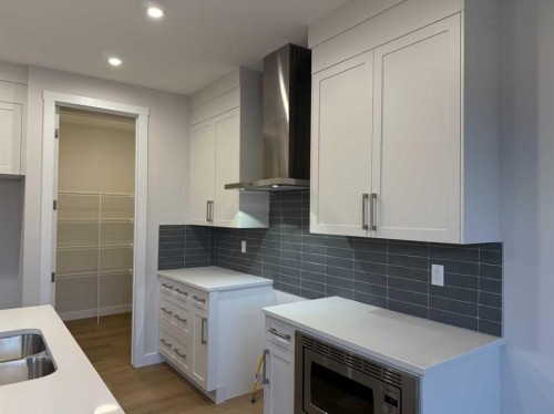 51 Sunrise Heath, Cochrane, AB - Indoor Photo Showing Kitchen With Double Sink