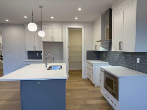 51 Sunrise Heath, Cochrane, AB - Indoor Photo Showing Kitchen With Double Sink With Upgraded Kitchen