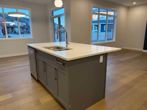 51 Sunrise Heath, Cochrane, AB - Indoor Photo Showing Kitchen With Double Sink