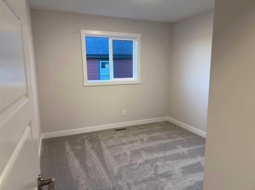 51 Sunrise Heath, Cochrane, AB - Indoor Photo Showing Other Room