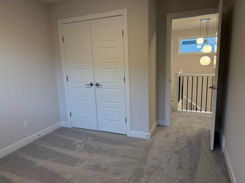 51 Sunrise Heath, Cochrane, AB - Indoor Photo Showing Other Room