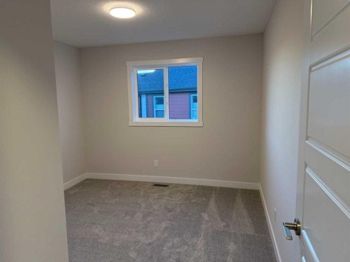 51 Sunrise Heath, Cochrane, AB - Indoor Photo Showing Other Room