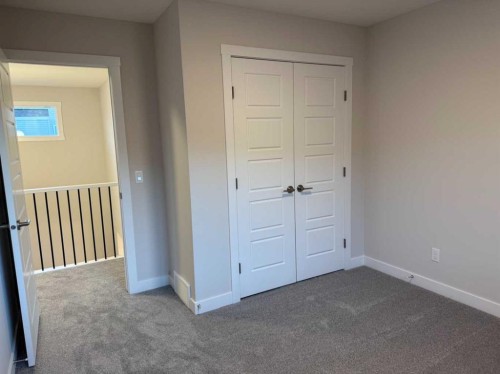 51 Sunrise Heath, Cochrane, AB - Indoor Photo Showing Other Room