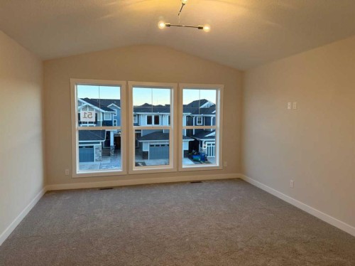 51 Sunrise Heath, Cochrane, AB - Indoor Photo Showing Other Room