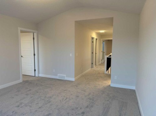 51 Sunrise Heath, Cochrane, AB - Indoor Photo Showing Other Room