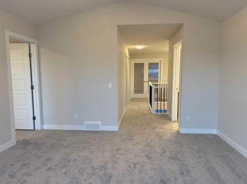 51 Sunrise Heath, Cochrane, AB - Indoor Photo Showing Other Room