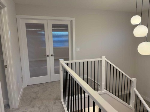 51 Sunrise Heath, Cochrane, AB - Indoor Photo Showing Other Room