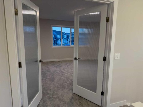 51 Sunrise Heath, Cochrane, AB - Indoor Photo Showing Other Room