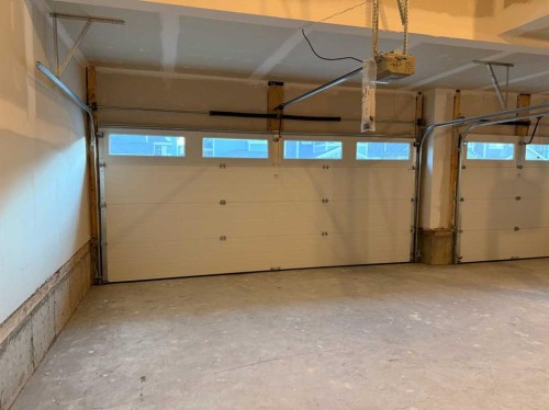 51 Sunrise Heath, Cochrane, AB - Indoor Photo Showing Garage