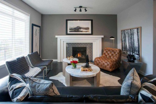 51 Sunrise Heath, Cochrane, AB - Indoor Photo Showing Living Room With Fireplace