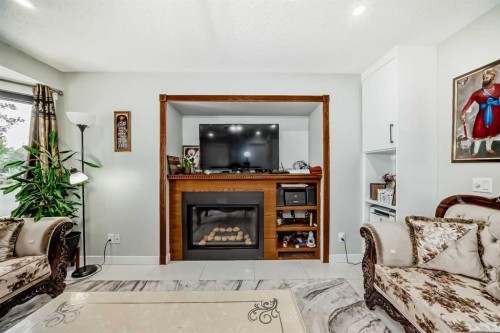 49 Taravista Way Ne, Calgary, AB - Indoor Photo Showing Living Room With Fireplace