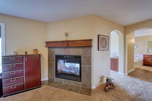 66 Crystal Green Drive, Okotoks, AB - Indoor With Fireplace