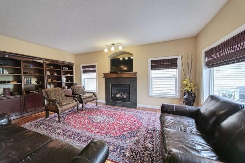 66 Crystal Green Drive, Okotoks, AB - Indoor Photo Showing Living Room With Fireplace