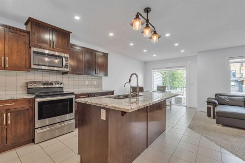 15 Kincora Crescent Nw, Calgary, AB - Indoor Photo Showing Kitchen With Stainless Steel Kitchen With Double Sink With Upgraded Kitchen